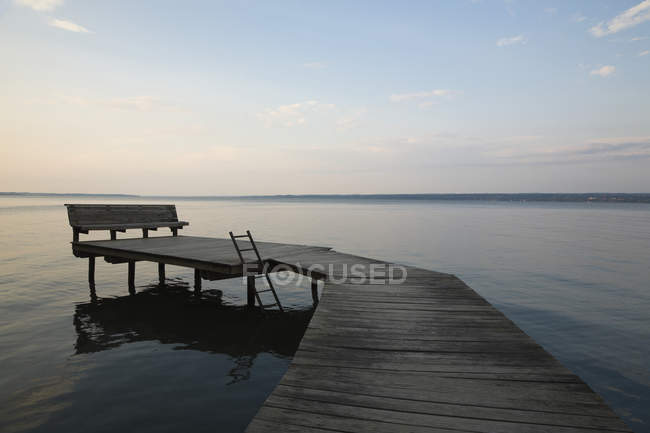 Wooden dock at sunset on Cayuga Lake, New York, USA. — Stock Photo