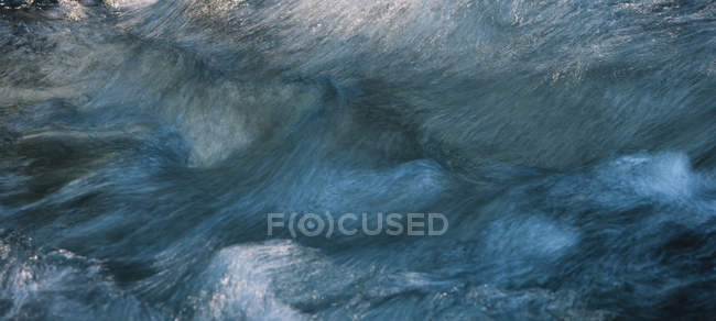 Close-up abstract of flowing river water — Stock Photo