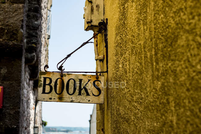 Nahaufnahme des Buchhandelschildes in einer engen Gasse in Pembrokeshire, Wales, Großbritannien. — Stockfoto