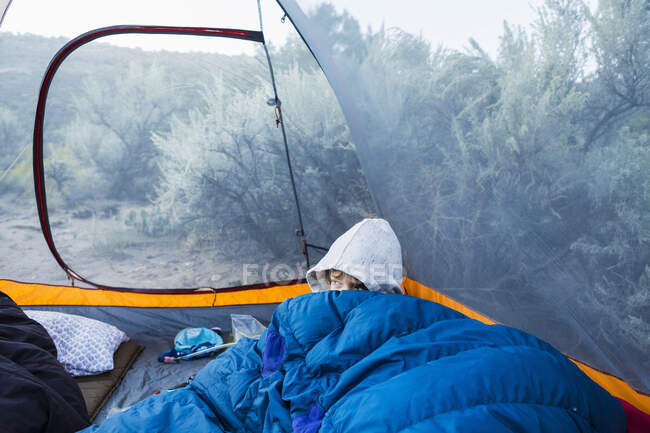 6 yera old boy waking up in tent — Stock Photo