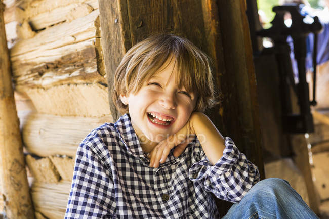 Portrait of pre-teen boy laughing in barn — Stock Photo