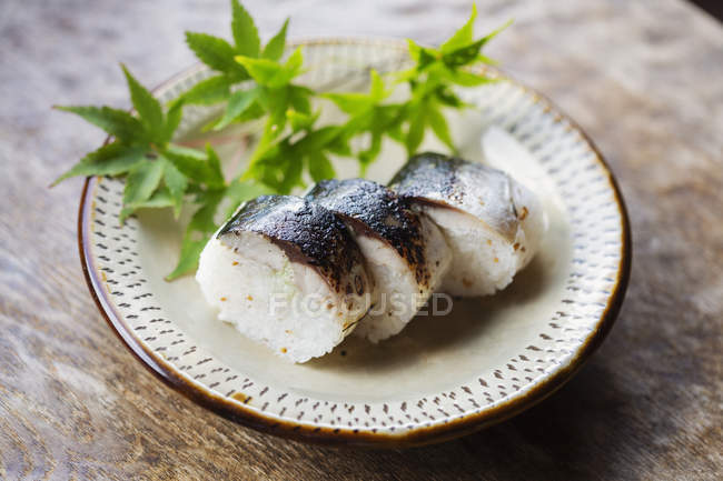 High angle close-up of plate of sushi on table in Japanese restaurant. — Stock Photo