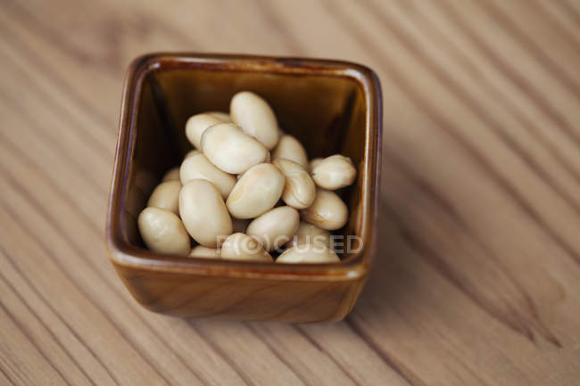 High angle close-up of a bowl of white beans in a vegetarian cafe. — Stock Photo