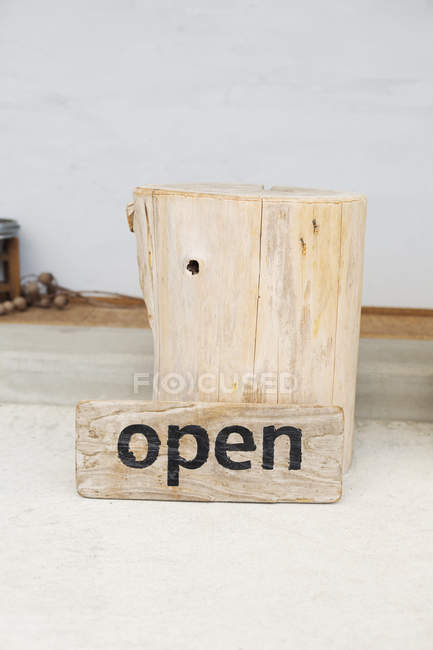 Close-up of wooden Open sign of vegetarian cafe. — Stock Photo
