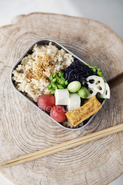High angle close-up of vegetarian Japanese food bento and chopsticks in a cafe. — Stock Photo