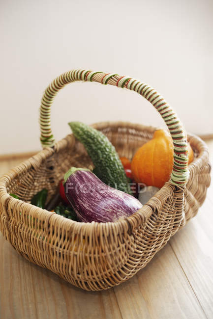 High angle close-up of basket with fresh vegetables. — Stock Photo