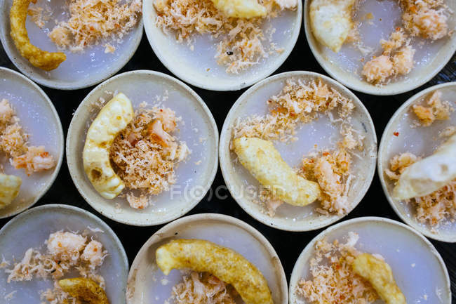 High angle close-up of Banh beo sticky rice with dried shrimp and pork crackling. — Stock Photo