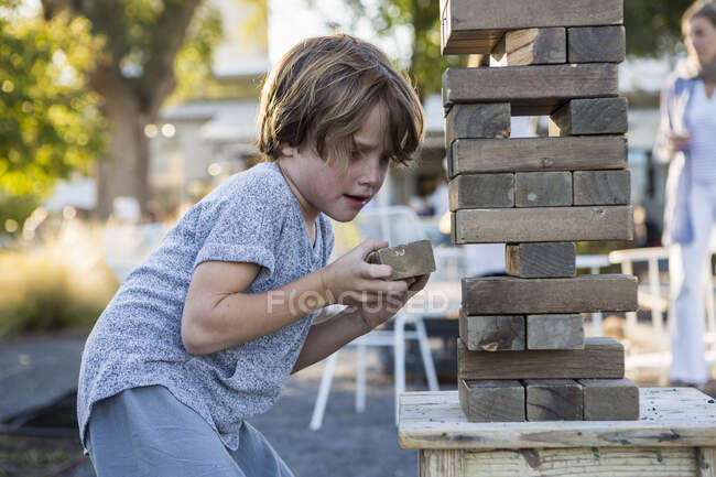 6-річний хлопчик грає з гігантською головоломкою — стокове фото
