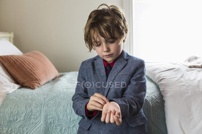 6 year old boy adjusting his watch band — Stock Photo