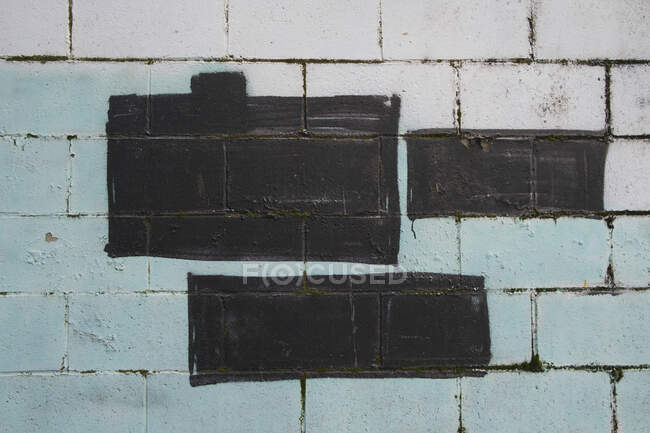 Black and green paint covering graffiti tags on building wall — Stock Photo