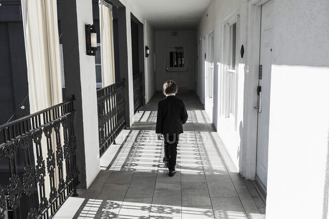 6 year old boy walking down corridor — Stock Photo