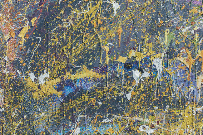 Close-up view of colorful graffiti paint splatters on urban wall, abstract background — Stock Photo