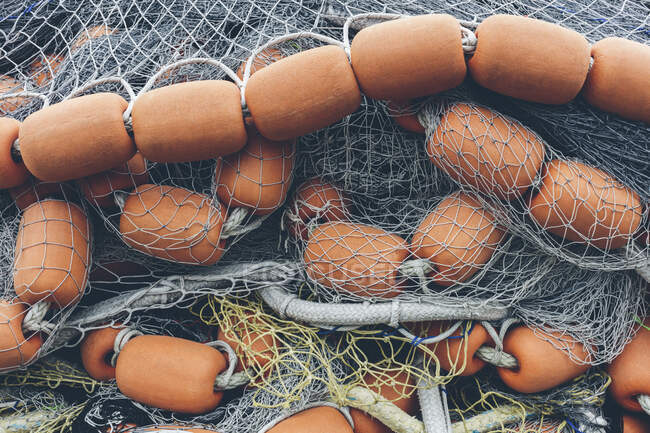 Pile de filets de pêche commerciale et filets maillants sur un quai de pêche, gros plan — Photo de stock