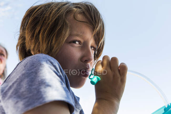 6 anno vecchio ragazzo sorseggiando acqua da idratazione vescica — Foto stock