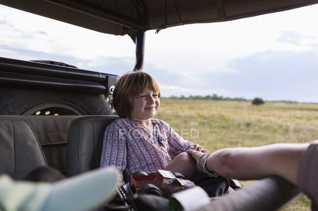 Um menino de cinco anos em safari, em um veículo em uma reserva de caça — Fotografia de Stock