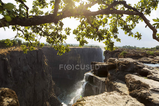 Victoria Falls from the Zambian side, view of the vertical cliffs of the river gorge, and water flowing fast. — Stock Photo