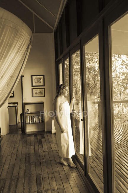 12 year old girl looking out window, hotel, Botswana — Stock Photo