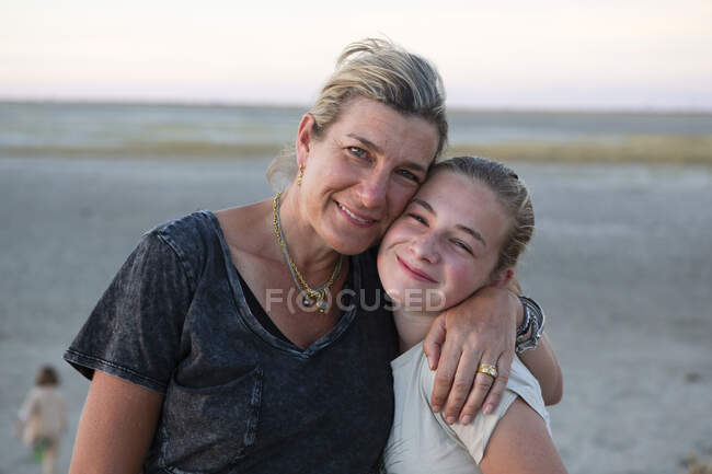 Woman a young teenage girl, a mother and her daughter hugging, a family holiday. — Stock Photo