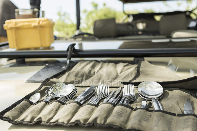 Veículo Safari, talheres em uma bolsa, e uma caixa de refrigeração amarela. — Fotografia de Stock