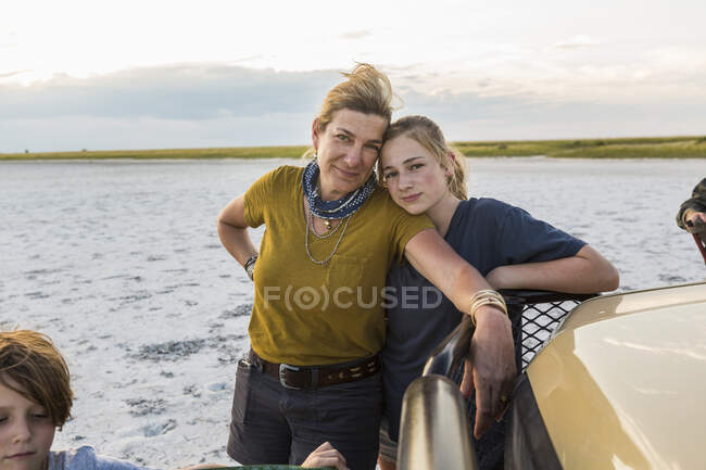Mother and teenage daughter standing side by side at the end of a day on safari. — Stock Photo