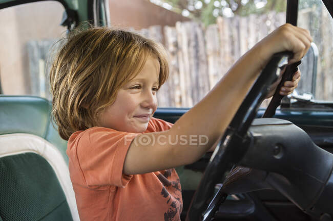 5 year old boy behind the wheel of 1970's pick up truck, NM. — Stock Photo