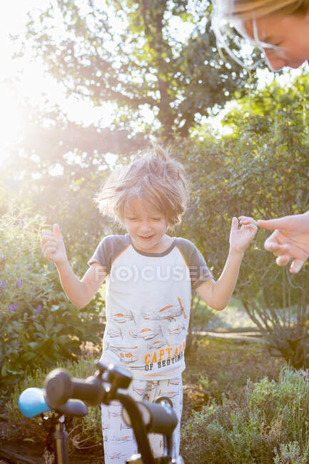 5 year old boy with his bike in early morning light — Stock Photo