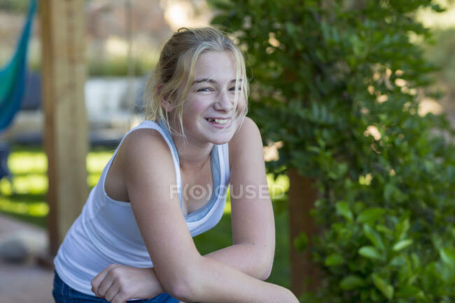 Portrait of cute smiling 11 year old  girl on scooter — Stock Photo