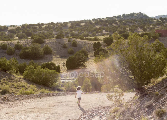 Four year old boy hiking in a rural landscape — Stock Photo