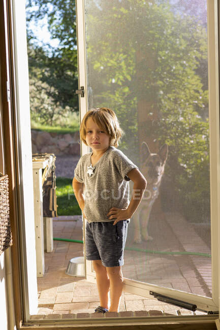 Portrait of 4 year old boy on his front porch — Stock Photo