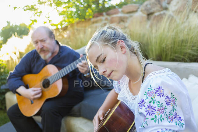 11 year old girl playing guitar — Stock Photo