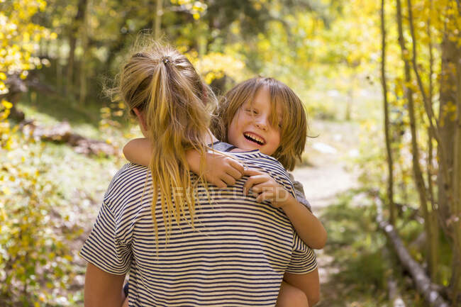 4 year old boy laughing on nature trail — Stock Photo