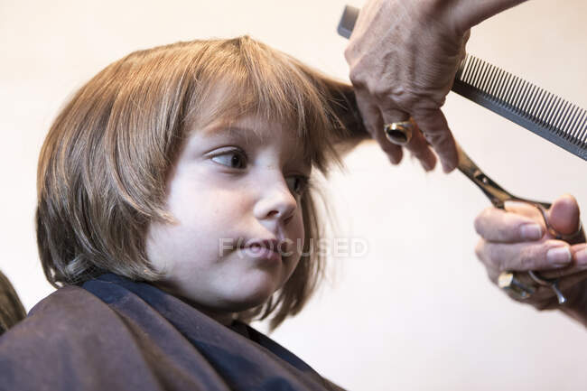4 anno vecchio ragazzo ottenere un taglio di capelli, ritagliato colpo — Foto stock