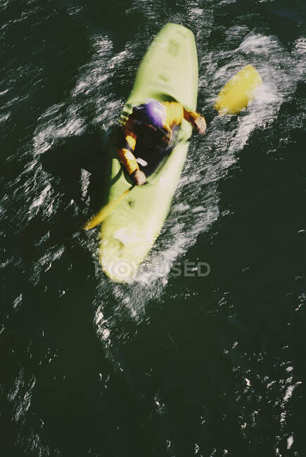 Overhead view of whitewater kayaker paddling rapids on a fast flowing river. — Stock Photo