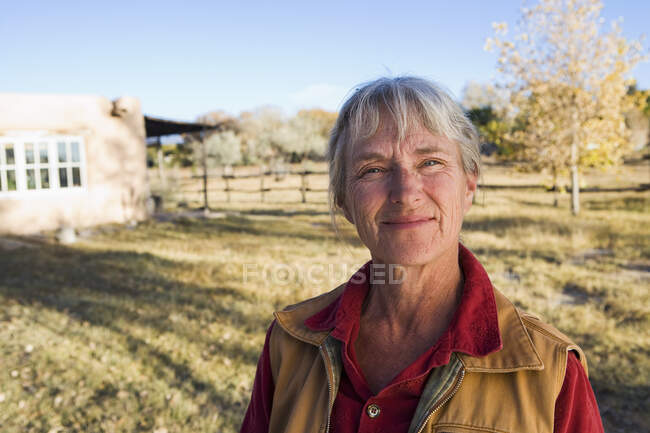 Mature woman at home on her property in a rural setting — Stock Photo