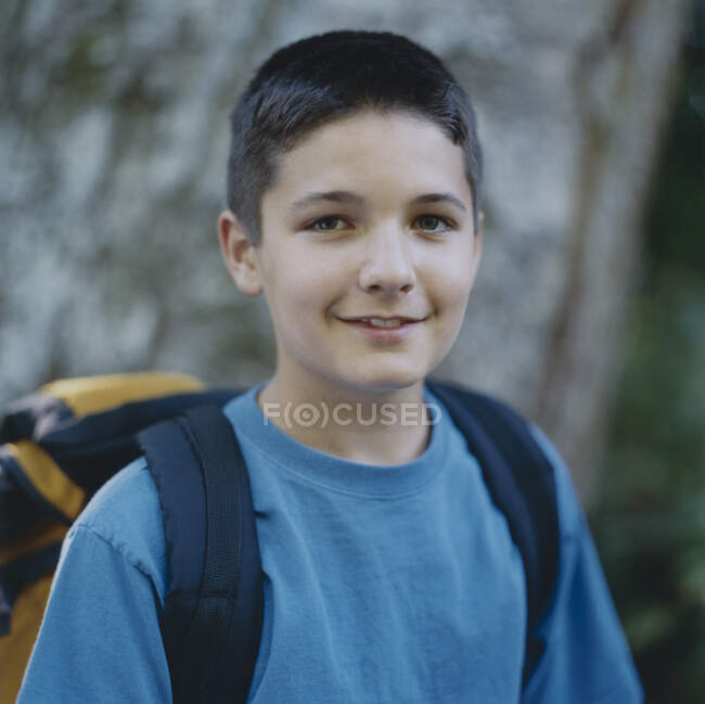 Portrait of happy adolescent boy wearing backpack — Stock Photo