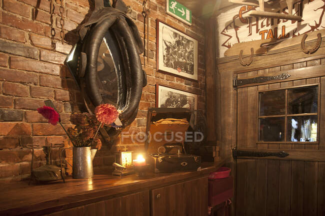 A hotel with old fashioned retro styled rooms, and rustic objects, bar with horse harness. — Stock Photo