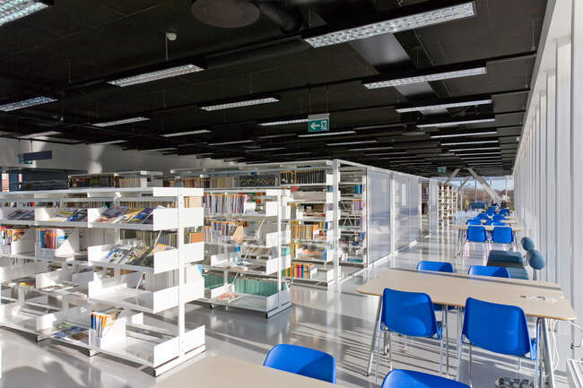 Public library, modern interior with shelves of books — Stock Photo