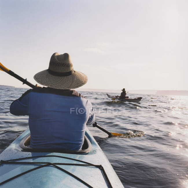 Middle aged man and woman sea kayaking. — Stock Photo