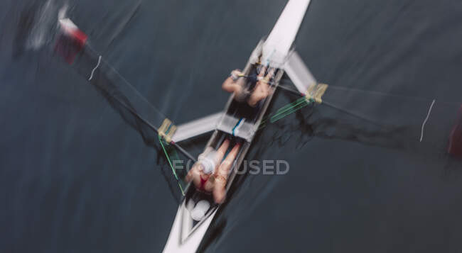 Overhead view of two people rowing in a scull, a pair in a boat — Stock Photo