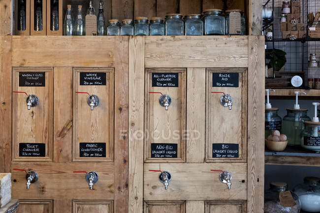 Close up of wooden dispensers for cleaning products in a waste free wholefood store. — Stock Photo