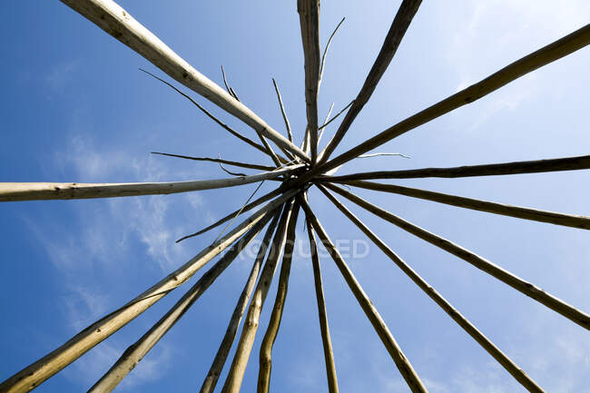 Low angle view, posts fixed together splayed out. — Stock Photo