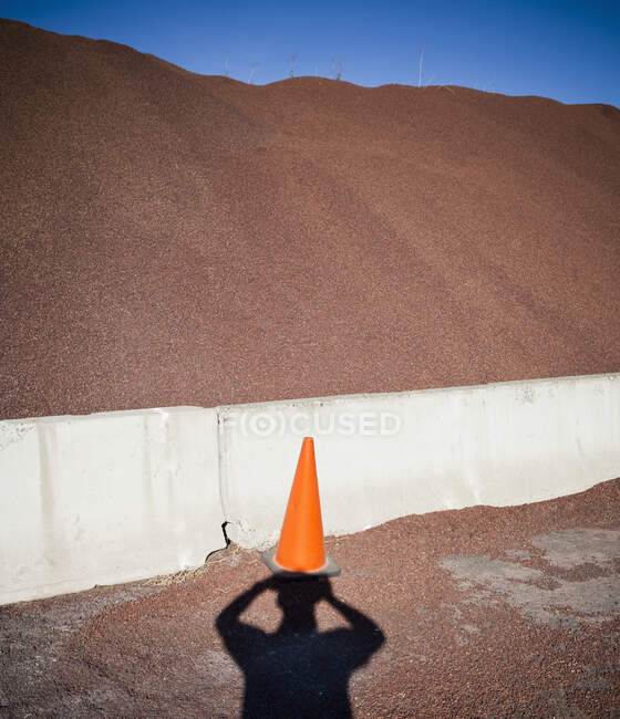 Heap of sand or gravel and shadow of a person — Stock Photo