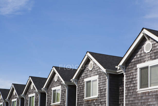 Row of houses, all the same, pitched roof and upstairs window — Stock Photo