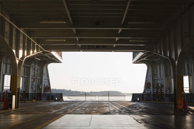 View from the freight deck of a roll on roll off ferry boat, departing the shore, empty. — Stock Photo
