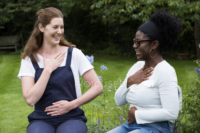 Therapist and client placing hands on their chest and stomach — Stock Photo