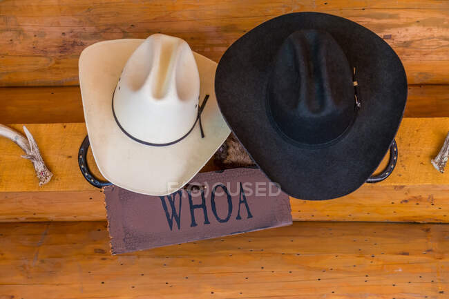 Primer plano de sombreros de vaquero colgando en un rancho, Colombia Británica, Canadá. - foto de stock