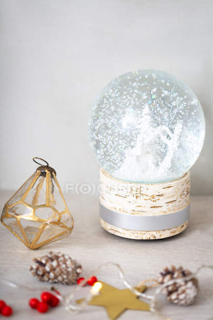 Close up view of Christmas decorations and snow globe. — Stock Photo