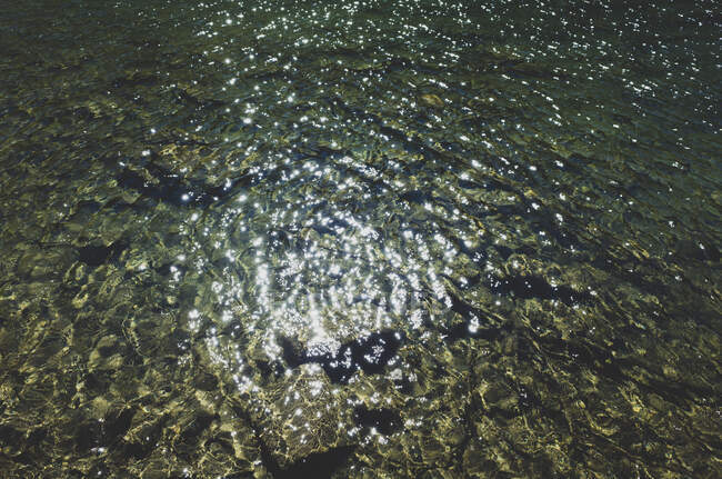 Detalhe da luz solar refletindo sobre a água do lago alpino claro, ao longo do Pacific Crest Trail — Fotografia de Stock