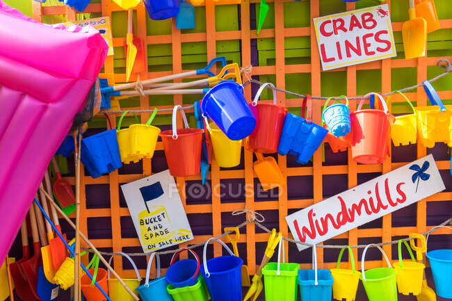Buckets and spades and other beach items for sale, holiday resort, England, United Kingdom — Stock Photo