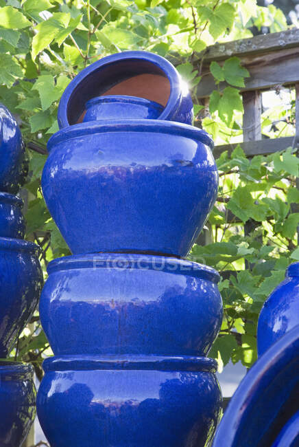 Stacked painted blue pots in garden center. — Stock Photo